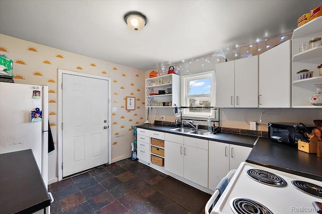 1769 W Warren Ave, Detroit, MI 48208 - kitchen with open shelves, white appliances, wallpapered walls, dark countertops, and white cabinetry