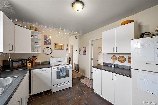 1769 W Warren Ave, Detroit, MI 48208 - kitchen with white appliances, dark stone finish floors, dark countertops, and white cabinets