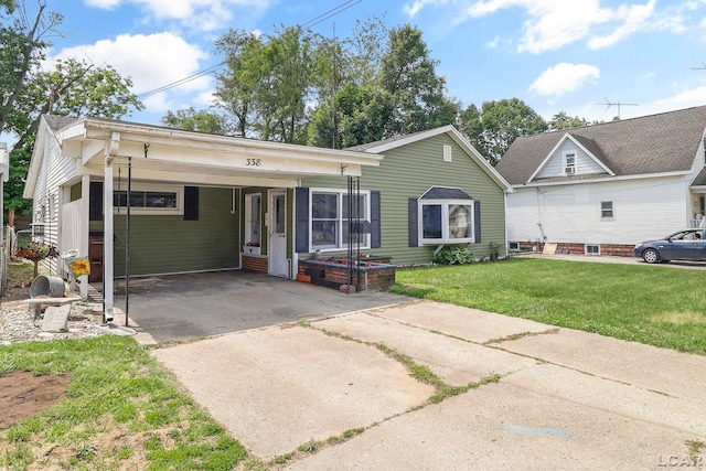 338 Cherry St, Blissfield, MI 49228 - view of front of house with a front lawn, driveway, and a carport