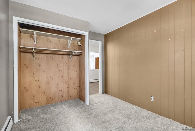 338 Cherry St, Blissfield, MI 49228 - unfurnished bedroom featuring carpet floors, a baseboard radiator, and wooden walls