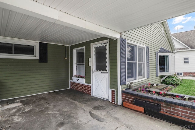 338 Cherry St, Blissfield, MI 49228 - doorway to property with an attached carport