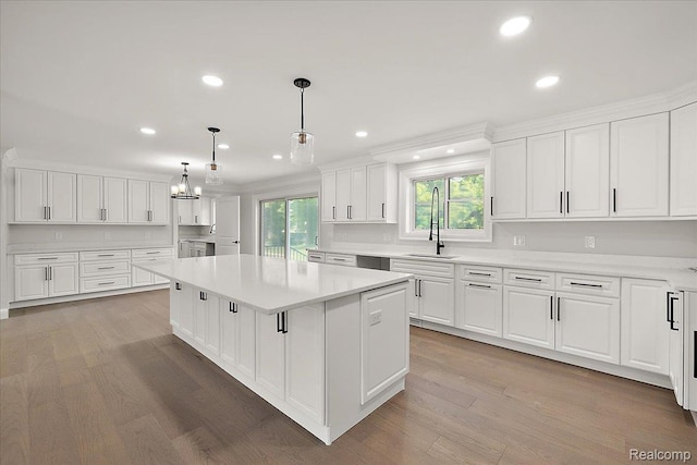 56350 Willow Creek Blvd, Utica, MI 48316 - kitchen featuring a kitchen island, white cabinetry, light countertops, recessed lighting, and light wood-style floors