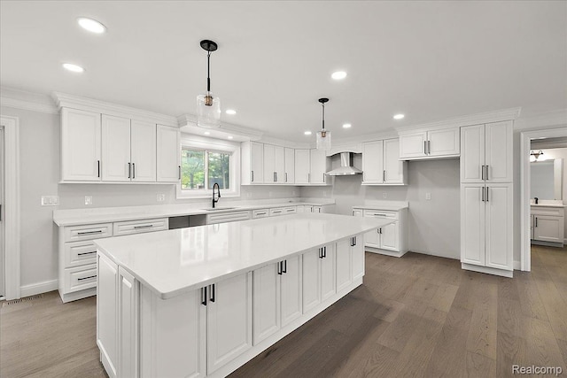 56350 Willow Creek Blvd, Utica, MI 48316 - kitchen with wall chimney range hood, a center island, recessed lighting, dark wood-style floors, and white cabinets