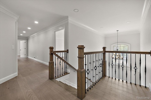 56350 Willow Creek Blvd, Utica, MI 48316 - hall featuring a chandelier, wood finished floors, an upstairs landing, recessed lighting, and crown molding