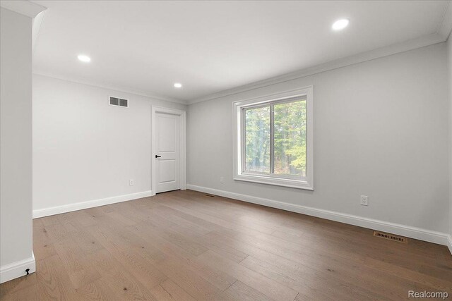 56350 Willow Creek Blvd, Utica, MI 48316 - empty room with ornamental molding, wood finished floors, and recessed lighting