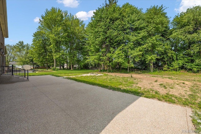 56350 Willow Creek Blvd, Utica, MI 48316 - view of green lawn with view of wooded area