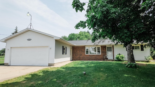2250 Pray Rd, Charlotte, MI 48813 - ranch-style house with a front yard, driveway, and a garage