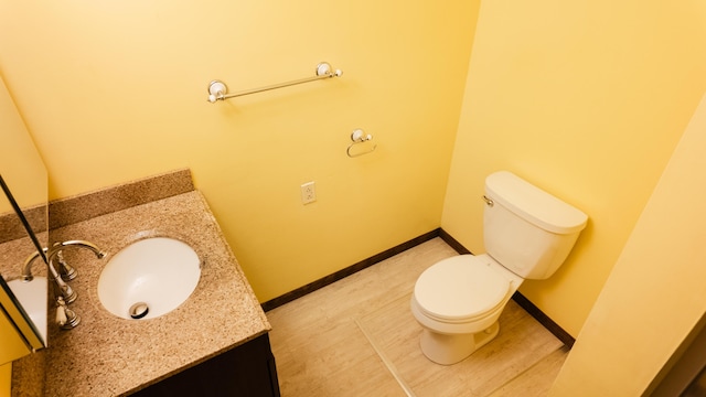 2250 Pray Rd, Charlotte, MI 48813 - half bathroom with vanity, pet washing area, and wood finished floors