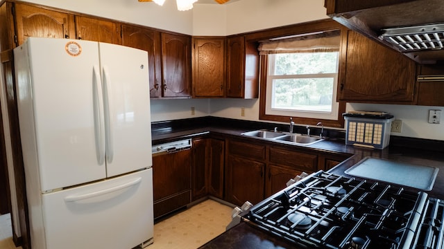 2250 Pray Rd, Charlotte, MI 48813 - kitchen featuring freestanding refrigerator, dishwashing machine, dark countertops, gas stove, and light flooring