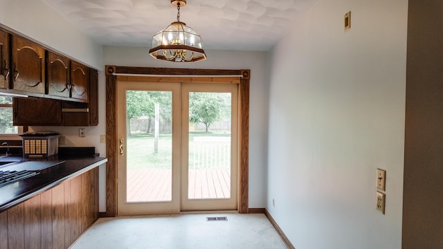 2250 Pray Rd, Charlotte, MI 48813 - doorway featuring a chandelier, plenty of natural light, and light flooring