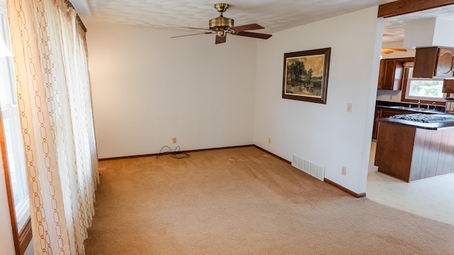 2250 Pray Rd, Charlotte, MI 48813 - unfurnished living room with a ceiling fan and light colored carpet