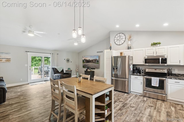 3328 S Vassar Rd, Burton, MI 48519 - kitchen with appliances with stainless steel finishes, lofted ceiling, open floor plan, light wood-style floors, and dark countertops