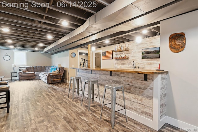3328 S Vassar Rd, Burton, MI 48519 - indoor wet bar featuring baseboards and wood finished floors