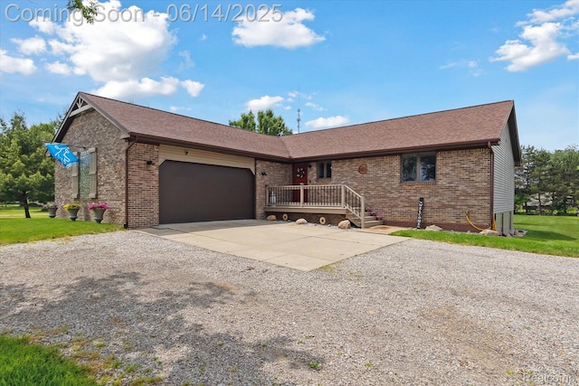 3328 S Vassar Rd, Burton, MI 48519 - single story home with gravel driveway, brick siding, an attached garage, and roof with shingles