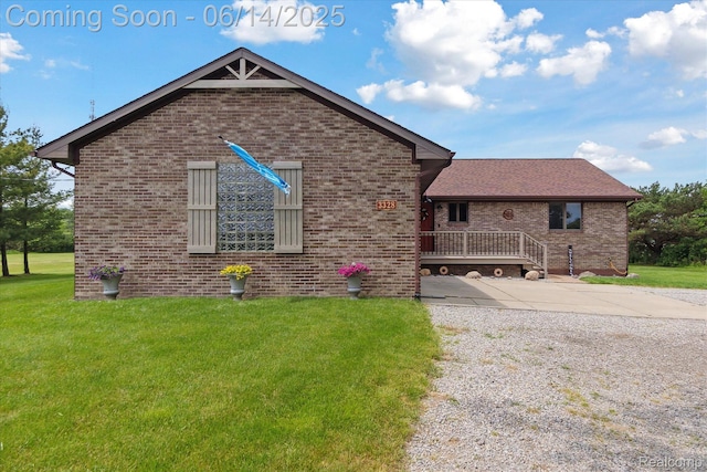 3328 S Vassar Rd, Burton, MI 48519 - view of front facade with brick siding, a front lawn, and driveway