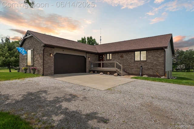 3328 S Vassar Rd, Burton, MI 48519 - ranch-style house featuring driveway, brick siding, a garage, and a shingled roof