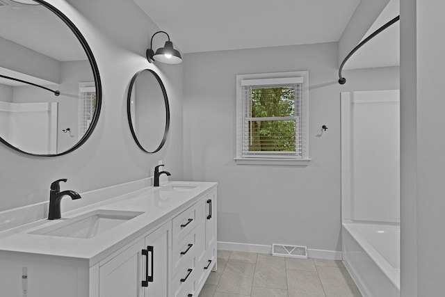 8475 Homerich Ave SW, Byron Center, MI 49315 - bathroom with double vanity, shower / washtub combination, and tile patterned floors