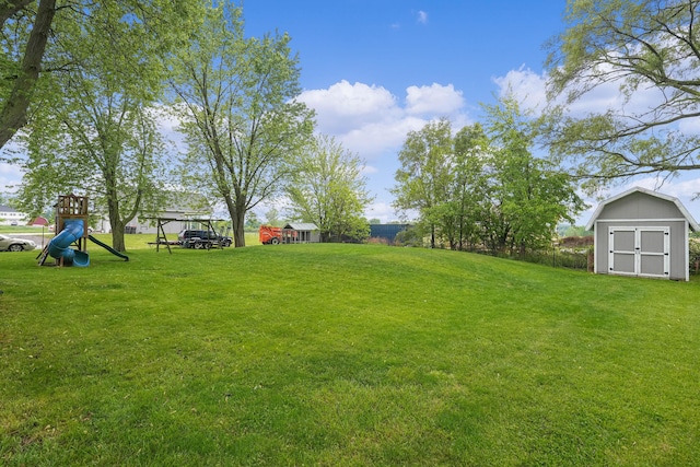 8475 Homerich Ave SW, Byron Center, MI 49315 - view of grassy yard featuring a storage unit and a playground