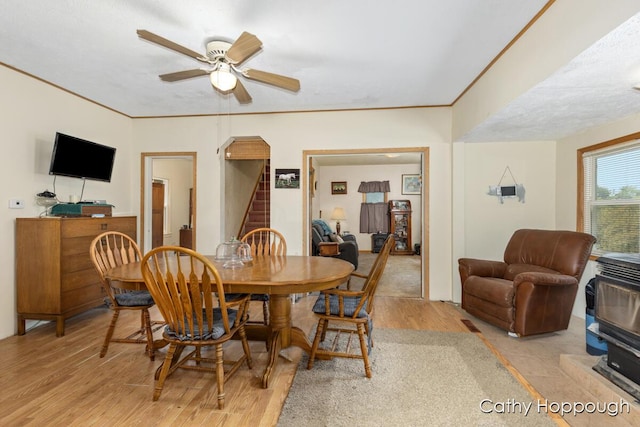 3119 S Hillman Rd, Sidney, MI 48885 - dining area with wood finished floors, ceiling fan, and stairway