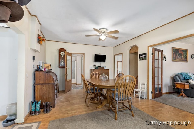 3119 S Hillman Rd, Sidney, MI 48885 - dining room featuring wood finished floors, ceiling fan, french doors, and arched walkways
