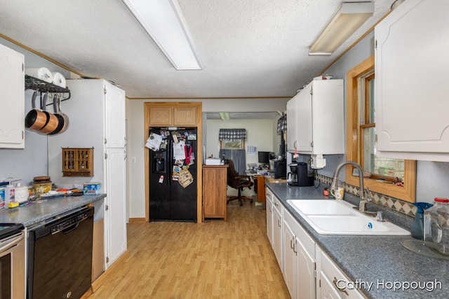 3119 S Hillman Rd, Sidney, MI 48885 - kitchen with black appliances, light wood-type flooring, white cabinets, dark countertops, and a textured ceiling