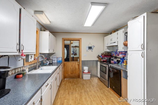3119 S Hillman Rd, Sidney, MI 48885 - kitchen featuring dishwasher, under cabinet range hood, white cabinetry, a textured ceiling, and a wainscoted wall