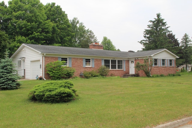 229 Riverside Dr, Hart, MI 49420 - ranch-style house with brick siding, a garage, a front lawn, and a chimney