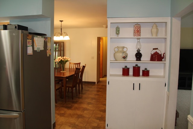 229 Riverside Dr, Hart, MI 49420 - kitchen with freestanding refrigerator, a chandelier, and open shelves