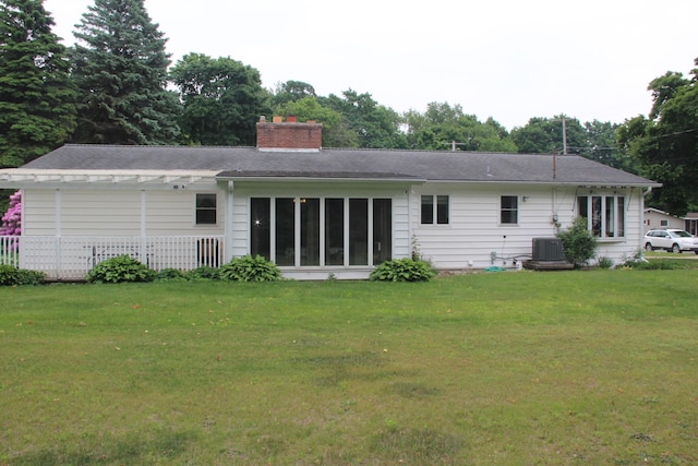 229 Riverside Dr, Hart, MI 49420 - back of house featuring a chimney and a lawn
