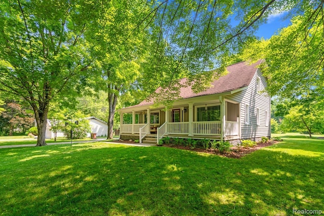 20551 Elwell Rd, Belleville, MI 48111 - view of front facade with covered porch, a front lawn, and a shingled roof