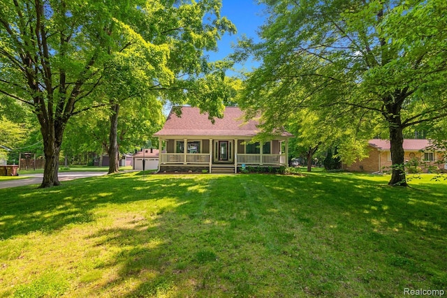 20551 Elwell Rd, Belleville, MI 48111 - view of front of home featuring a porch and a front lawn