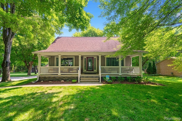 20551 Elwell Rd, Belleville, MI 48111 - view of front facade featuring covered porch, a front yard, board and batten siding, and a shingled roof