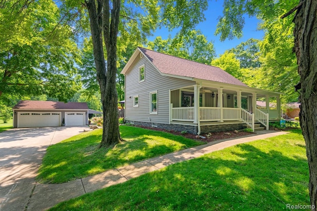 20551 Elwell Rd, Belleville, MI 48111 - view of front of home with a porch, an outdoor structure, a detached garage, and a front yard
