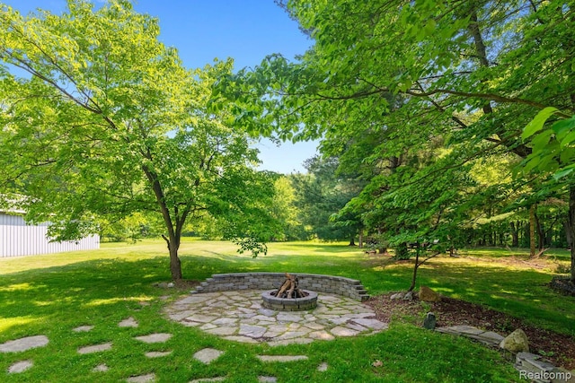 20551 Elwell Rd, Belleville, MI 48111 - view of green lawn featuring an outdoor fire pit