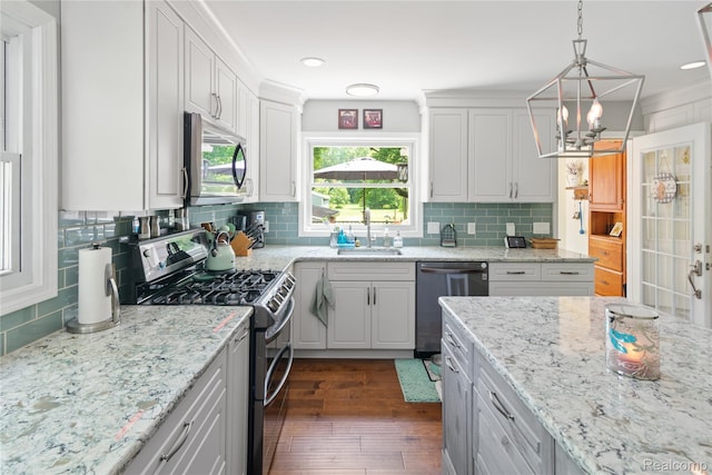 20551 Elwell Rd, Belleville, MI 48111 - kitchen featuring stainless steel appliances, a chandelier, dark wood-style flooring, backsplash, and white cabinetry