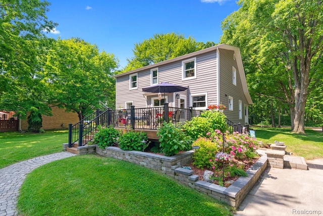 20551 Elwell Rd, Belleville, MI 48111 - back of property with a wooden deck and a yard