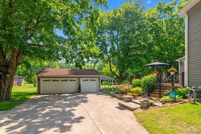 20551 Elwell Rd, Belleville, MI 48111 - view of green lawn featuring an outdoor structure and a garage