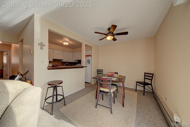7615 Woodview St # 3, Westland, MI 48185 - dining room featuring light carpet, a baseboard radiator, and a ceiling fan