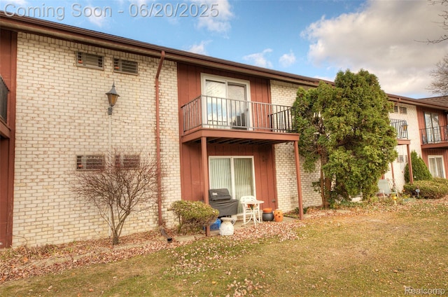 7615 Woodview St # 3, Westland, MI 48185 - rear view of property with a balcony, brick siding, and a yard