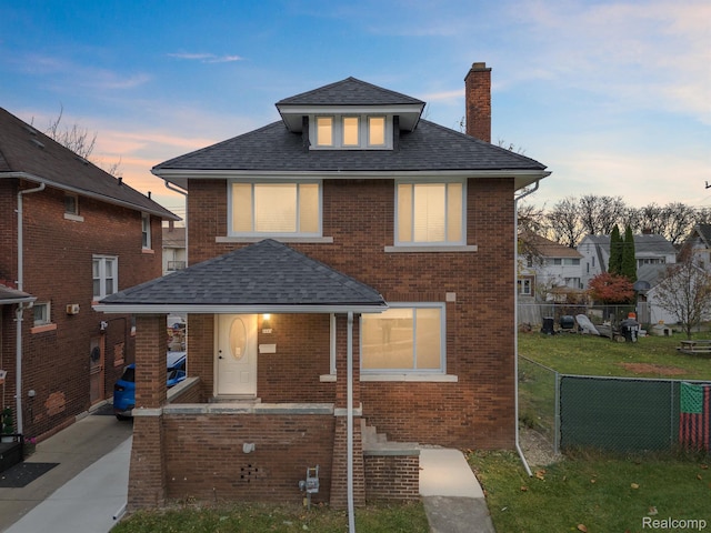 3297 Taylor St, Detroit, MI 48206 - view of front facade featuring a chimney, brick siding, and roof with shingles