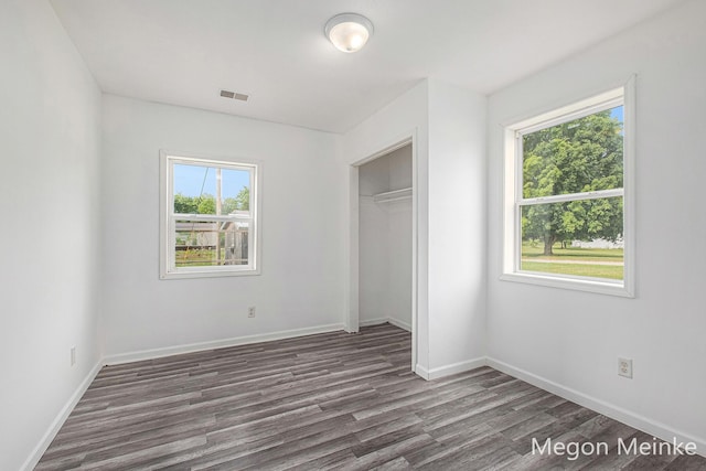 3682 W Long Lake Rd, Orleans, MI 48865 - unfurnished bedroom with dark wood finished floors and a closet