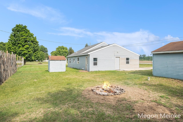 3682 W Long Lake Rd, Orleans, MI 48865 - rear view of house featuring a fire pit and a storage shed