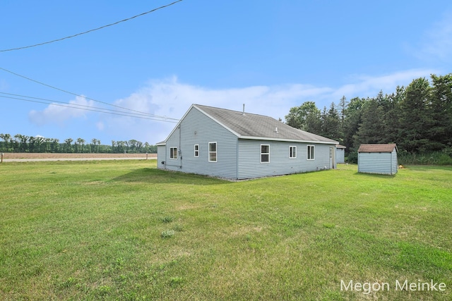 3682 W Long Lake Rd, Orleans, MI 48865 - view of side of home with a lawn and a storage shed