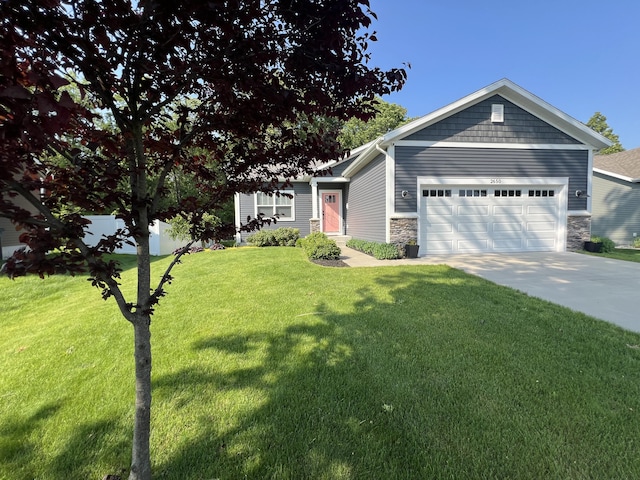 2650 Eagle Rdg, Muskegon, MI 49444 - view of front of house with an attached garage, stone siding, and driveway