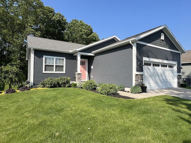 2650 Eagle Rdg, Muskegon, MI 49444 - view of front facade with a garage, a front yard, concrete driveway, and a shingled roof
