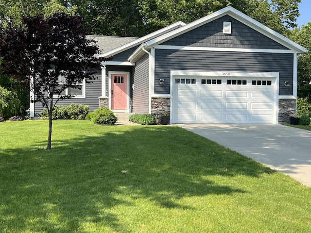 2650 Eagle Rdg, Muskegon, MI 49444 - view of front of house featuring stone siding, an attached garage, a front yard, and driveway