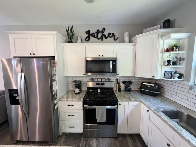 2650 Eagle Rdg, Muskegon, MI 49444 - kitchen with appliances with stainless steel finishes, dark wood-style floors, white cabinets, tasteful backsplash, and open shelves