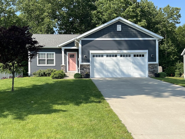 2650 Eagle Rdg, Muskegon, MI 49444 - view of front of property featuring an attached garage, stone siding, concrete driveway, and a front lawn