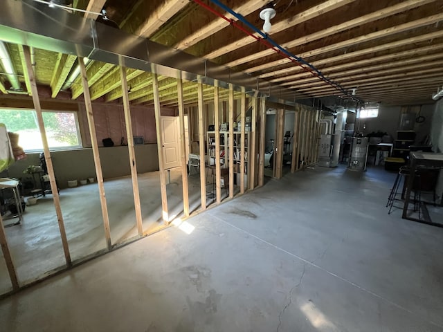 2650 Eagle Rdg, Muskegon, MI 49444 - miscellaneous room featuring healthy amount of natural light, concrete floors, and water heater