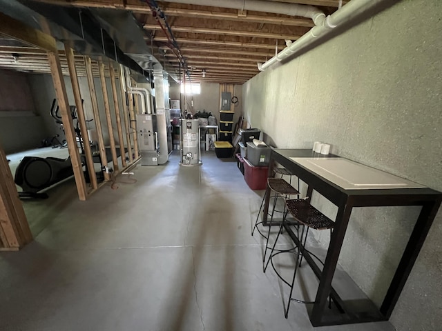 2650 Eagle Rdg, Muskegon, MI 49444 - unfinished below grade area with a textured wall, gas water heater, electric panel, and heating unit